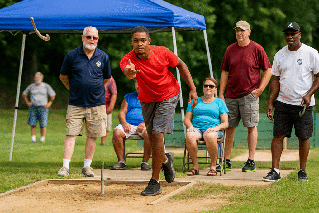 A young African American man focuses as he throws a horseshoe during a sunny competitive tournament match.