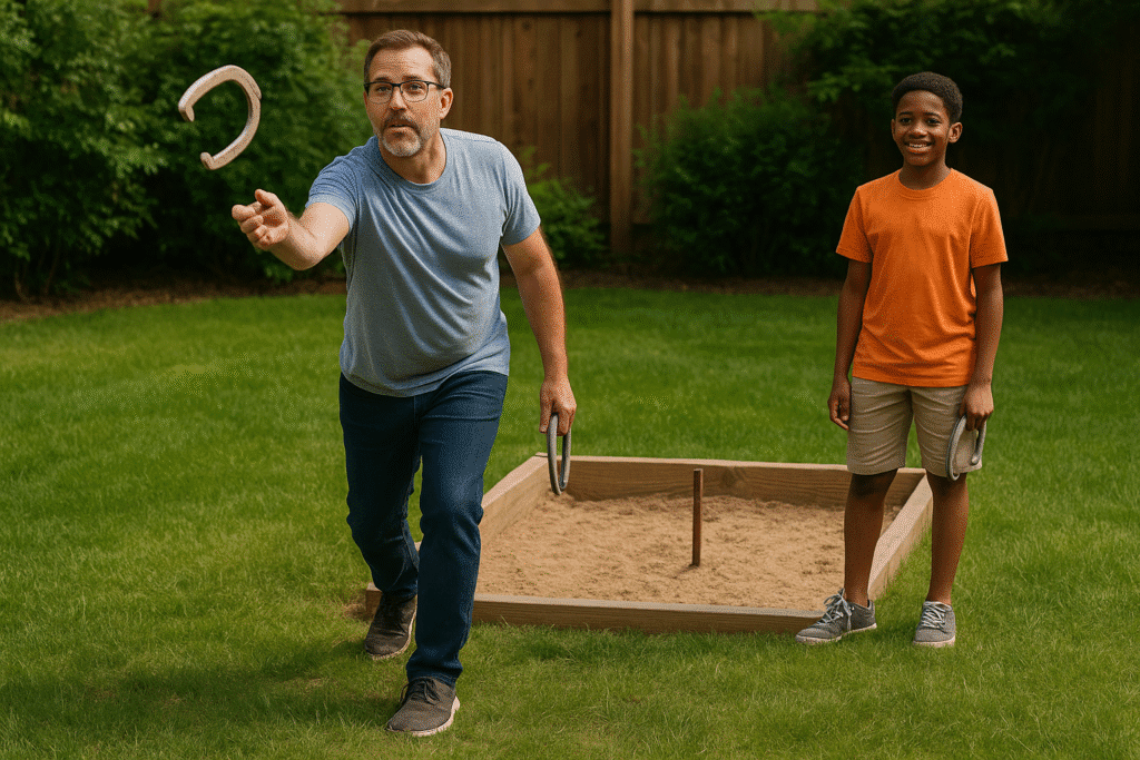 A middle-aged Caucasian man throws a horseshoe while a young African American boy watches and smiles beside a backyard pit.