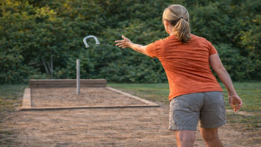 White female horseshoe player holding a relaxed follow-through with feet planted after releasing the horseshoe
